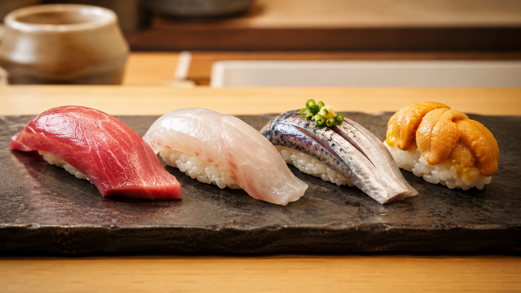 まぐろ、白身、鯖、雲丹など寿司の魚が静かに並ぶカウンター